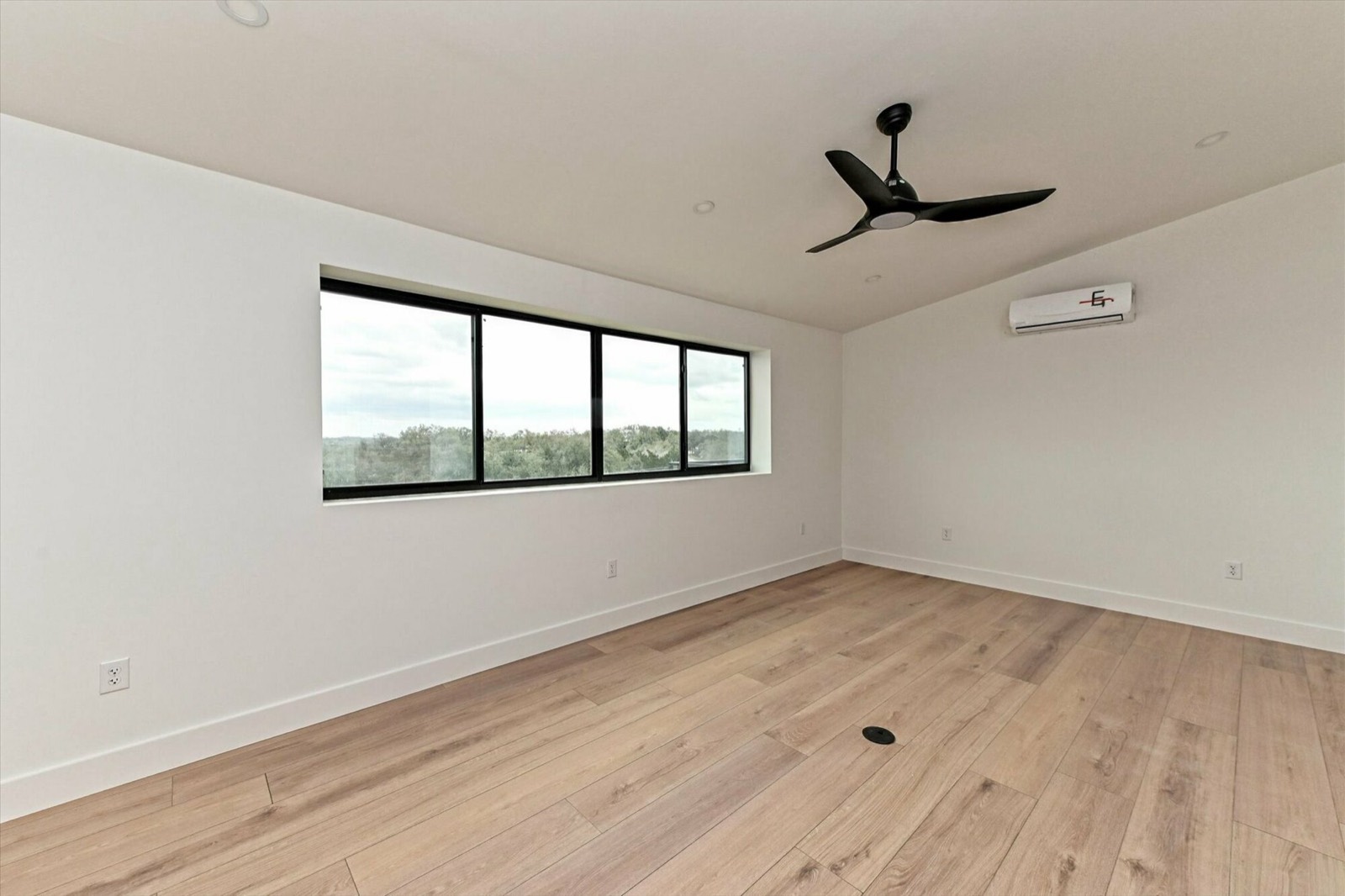 Finished interior with wood floors and large windows